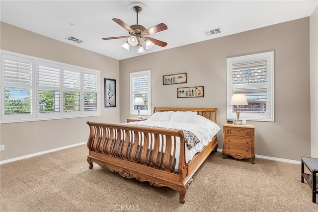 bedroom featuring visible vents, baseboards, and carpet