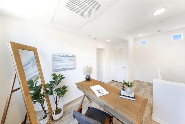 office with visible vents, baseboards, light wood finished floors, attic access, and recessed lighting