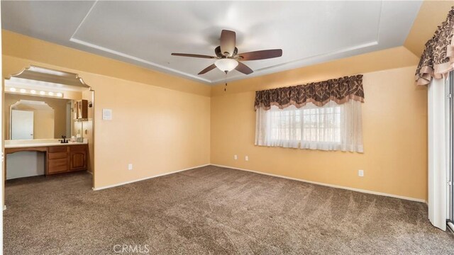 4176 Goss Rd, Phelan, CA 92371 - unfurnished bedroom featuring dark colored carpet, a raised ceiling, ensuite bathroom, and a ceiling fan