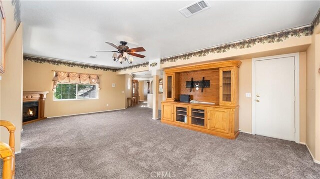 4176 Goss Rd, Phelan, CA 92371 - unfurnished living room with carpet flooring, a ceiling fan, and a lit fireplace