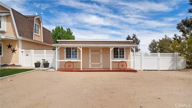 4176 Goss Rd, Phelan, CA 92371 - view of front of home featuring roof with shingles, a gambrel roof, and a porch