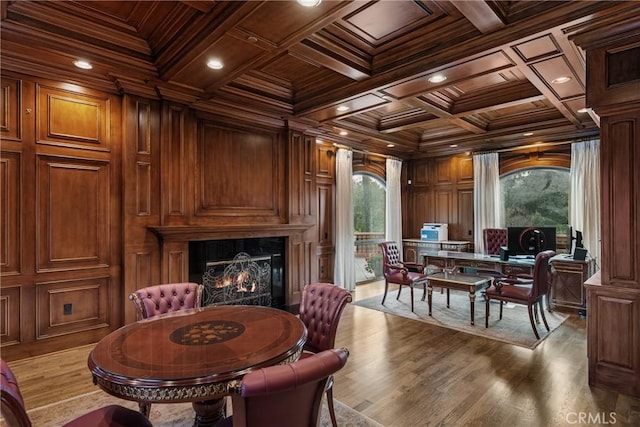 dining room with wooden ceiling, ornamental molding, beamed ceiling, and a warm lit fireplace
