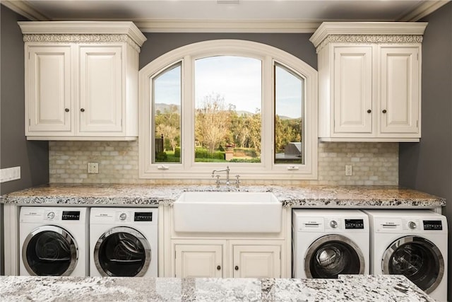 laundry room with separate washer and dryer, cabinet space, crown molding, and a sink