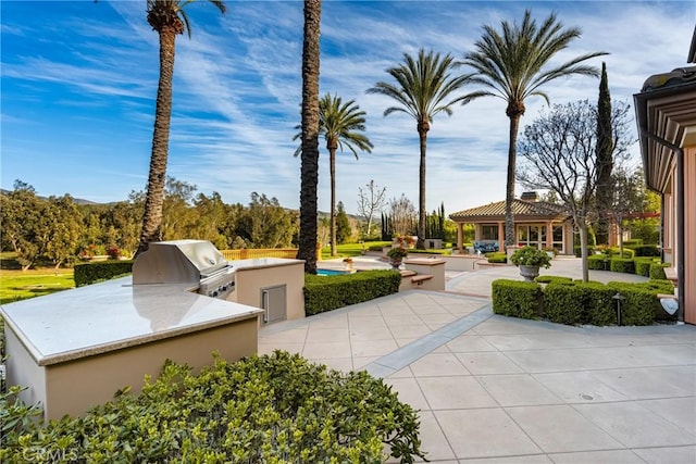 view of home's community with a gazebo, area for grilling, and a patio