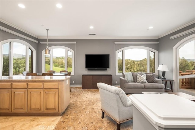 living room featuring ornamental molding, recessed lighting, baseboards, and a healthy amount of sunlight
