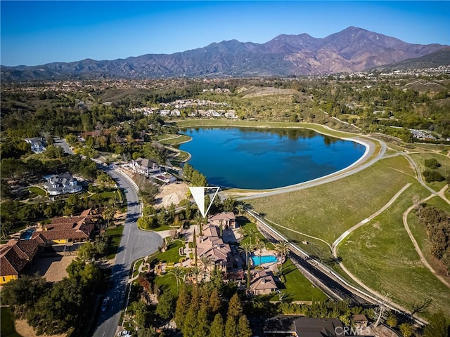 drone / aerial view with a water and mountain view