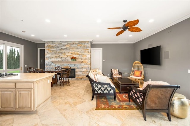 living area with crown molding, recessed lighting, a ceiling fan, and a fireplace