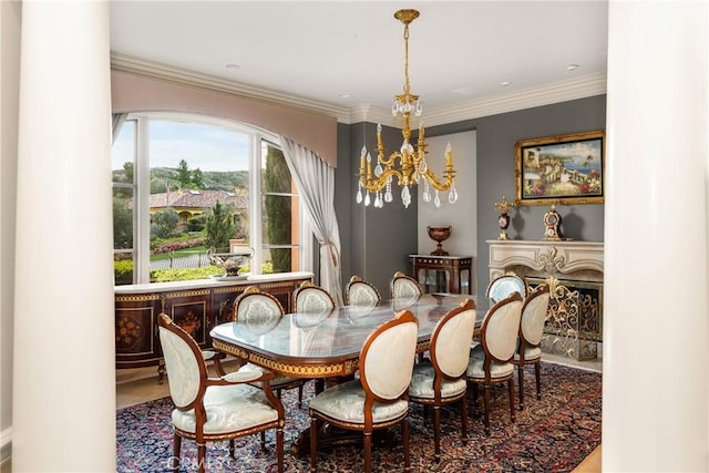 dining area featuring an inviting chandelier, a fireplace, and crown molding