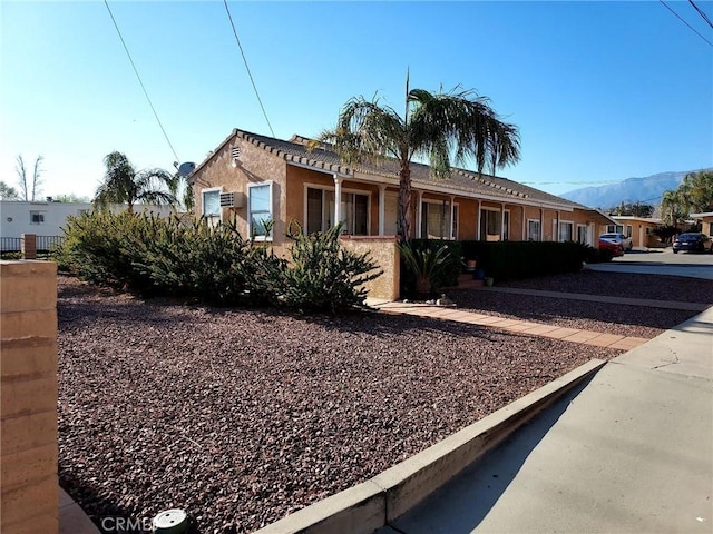 view of front of property with a mountain view and stucco siding