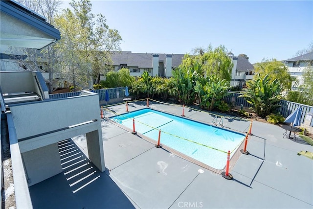 pool with a fenced backyard and a patio area