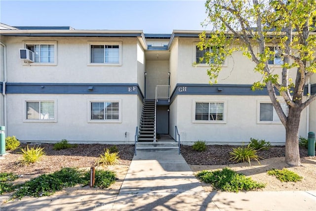 townhome / multi-family property featuring stucco siding and stairway