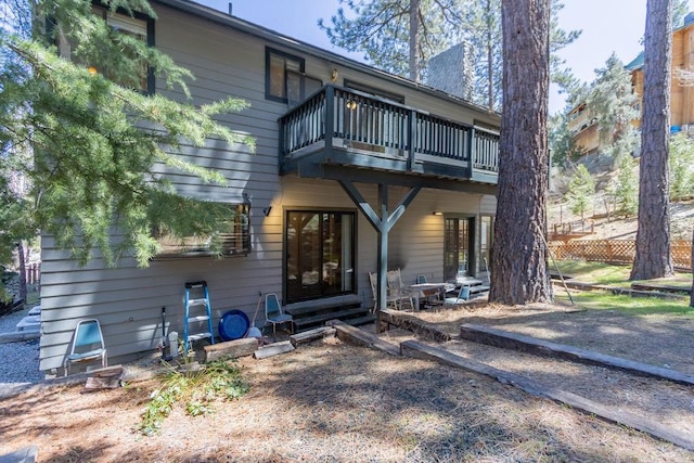 back of property featuring a balcony