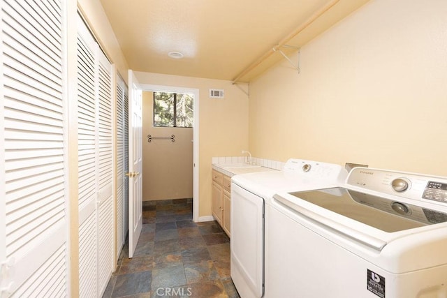 2405 Cedarwood Dr, Pine Mountain Club, CA 93222 - washroom featuring stone tile floors, washing machine and dryer, and cabinet space