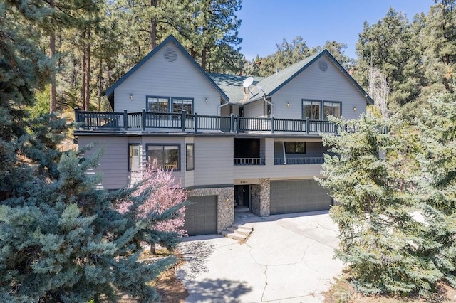 2405 Cedarwood Dr, Pine Mountain Club, CA 93222 - chalet / cabin featuring a balcony, a garage, stone siding, and concrete driveway