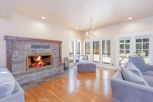 2405 Cedarwood Dr, Pine Mountain Club, CA 93222 - living room with a chandelier, a fireplace, wood finished floors, recessed lighting, and french doors