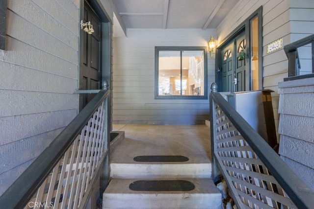 staircase featuring wood walls