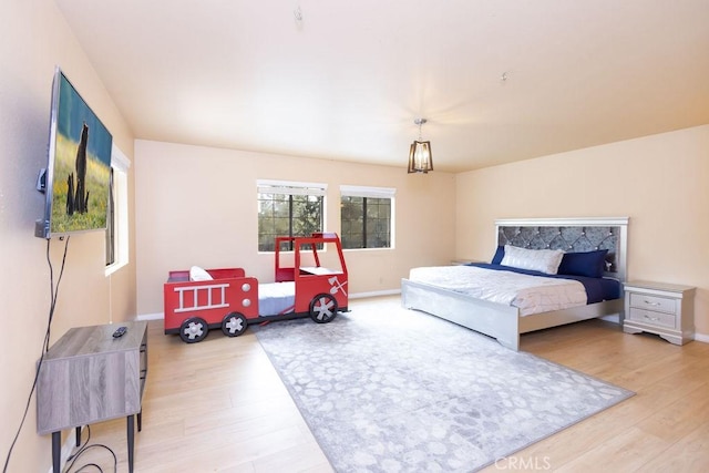 bedroom featuring baseboards and wood finished floors