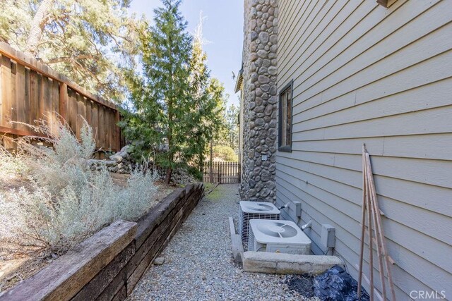 2405 Cedarwood Dr, Pine Mountain Club, CA 93222 - view of property exterior with fence and central AC unit
