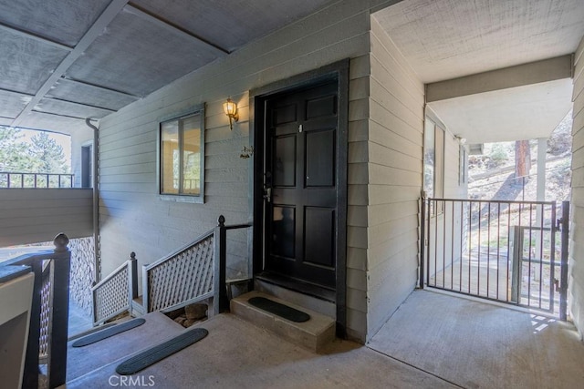 view of exterior entry featuring a porch