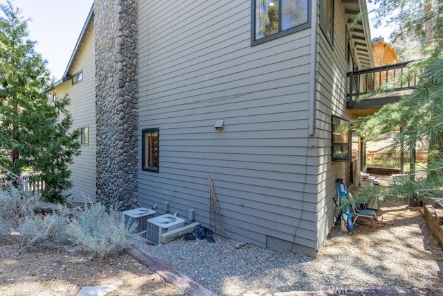 view of side of home featuring central AC