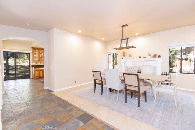 2405 Cedarwood Dr, Pine Mountain Club, CA 93222 - dining area with arched walkways, healthy amount of natural light, baseboards, and recessed lighting