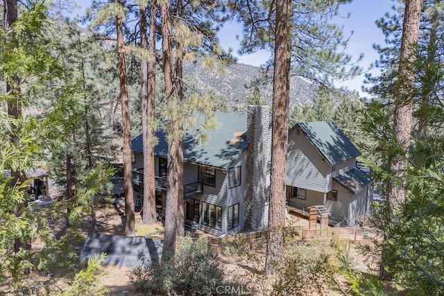 view of property exterior featuring a mountain view and a balcony