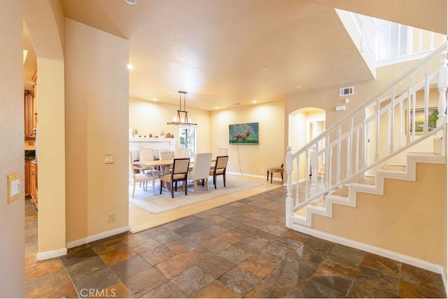 2405 Cedarwood Dr, Pine Mountain Club, CA 93222 - entryway with arched walkways, stone tile floors, baseboards, and recessed lighting