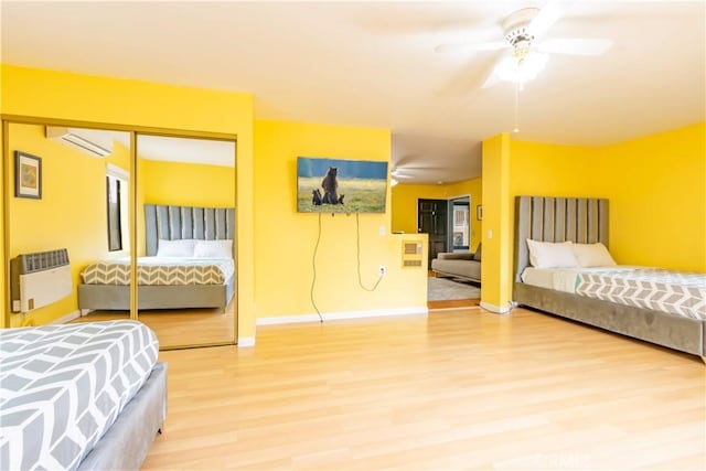 2405 Cedarwood Dr, Pine Mountain Club, CA 93222 - bedroom featuring a wall unit AC, heating unit, wood finished floors, baseboards, and a closet