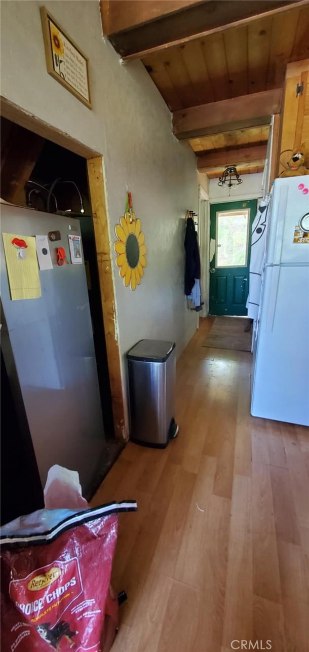 16937 Stagecoach Rd, Corning, CA 96021 - corridor featuring light wood-type flooring and beamed ceiling