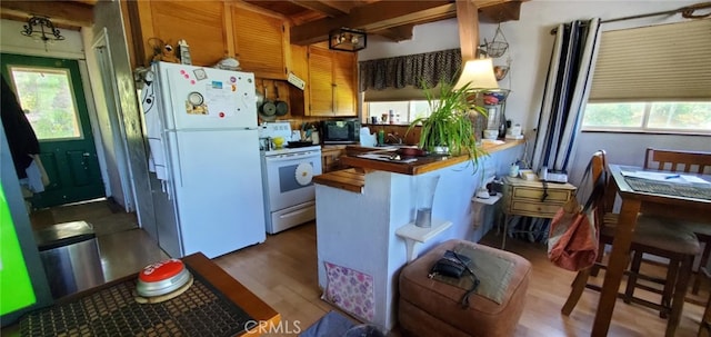 16937 Stagecoach Rd, Corning, CA 96021 - kitchen featuring wood finished floors, white appliances, a peninsula, and a sink