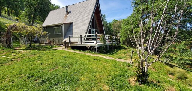 16937 Stagecoach Rd, Corning, CA 96021 - back of house featuring a lawn, fence, and a deck