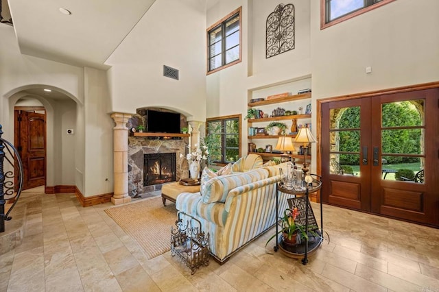 6314 El Apajo, Rancho Santa Fe, CA 92067 - living room featuring a high ceiling, arched walkways, french doors, and a fireplace