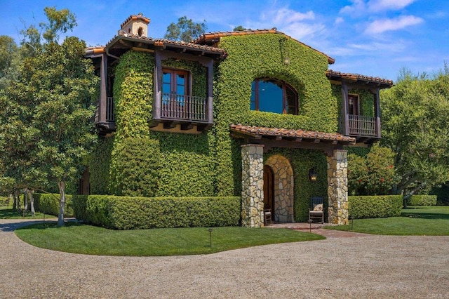 6314 El Apajo, Rancho Santa Fe, CA 92067 - mediterranean / spanish house featuring a balcony, a tile roof, a chimney, and a front lawn