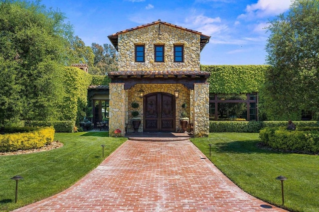 6314 El Apajo, Rancho Santa Fe, CA 92067 - mediterranean / spanish-style home featuring stone siding, french doors, and a front yard