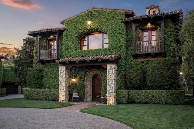 6314 El Apajo, Rancho Santa Fe, CA 92067 - mediterranean / spanish home with a tiled roof, stucco siding, a lawn, and a balcony