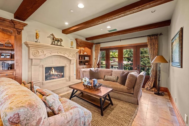 6314 El Apajo, Rancho Santa Fe, CA 92067 - living room with beam ceiling, a fireplace, recessed lighting, stone tile floors, and french doors