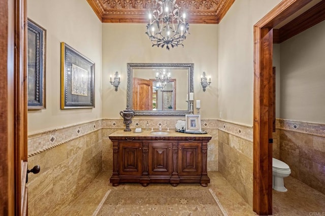 6314 El Apajo, Rancho Santa Fe, CA 92067 - bathroom featuring a chandelier, tile walls, ornamental molding, vanity, and wainscoting