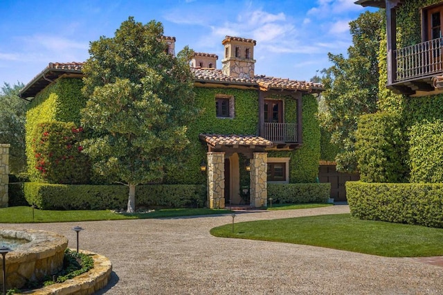 6314 El Apajo, Rancho Santa Fe, CA 92067 - mediterranean / spanish-style home featuring a tiled roof, a chimney, a balcony, and stone siding