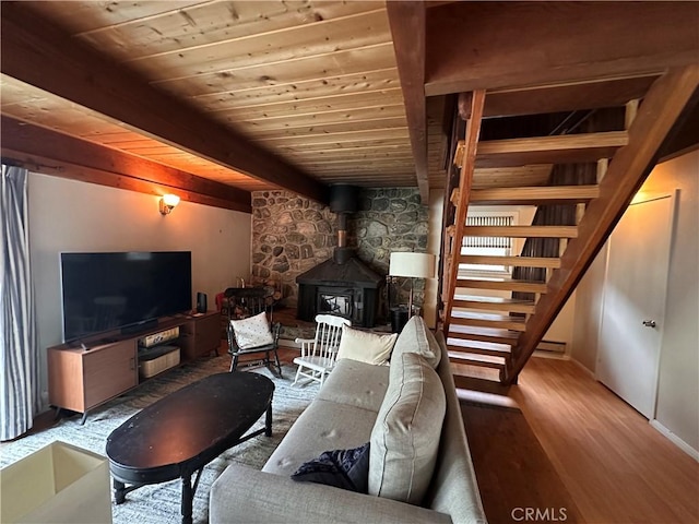 39500 Canyon Dr, Forest Falls, CA 92339 - living area with stairs, a wood stove, beamed ceiling, wood ceiling, and wood finished floors