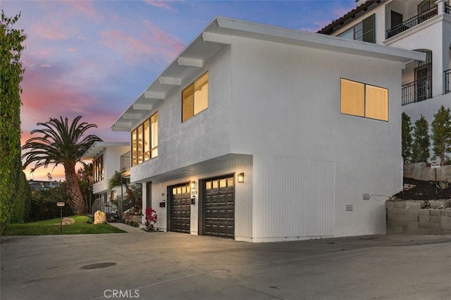 2516 Bayside Dr, Corona Del Mar, CA 92625 - property exterior at dusk with driveway, stucco siding, and an attached garage