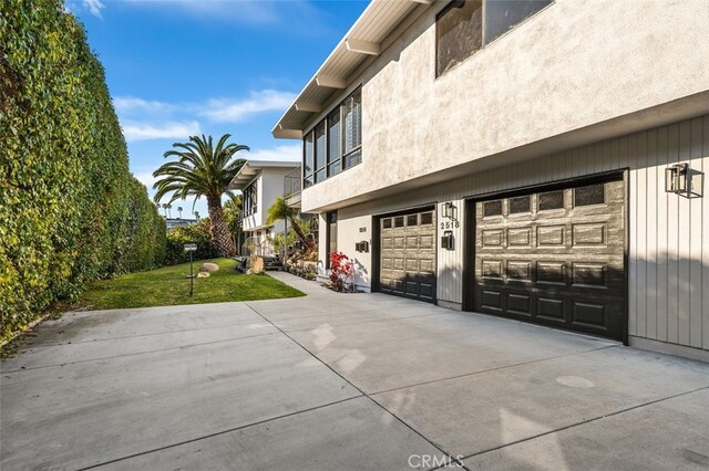 2516 Bayside Dr, Corona Del Mar, CA 92625 - view of property exterior featuring a garage, driveway, and a lawn