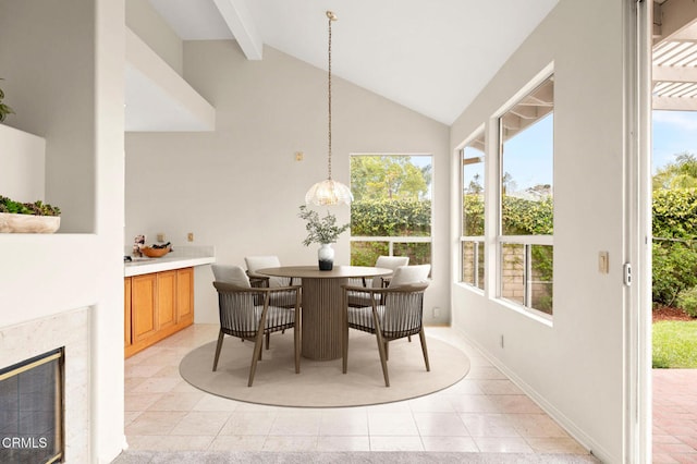 2101 Fox Den Ct, Oxnard, CA 93036 - dining space with a high end fireplace, a healthy amount of sunlight, beamed ceiling, and light tile patterned floors