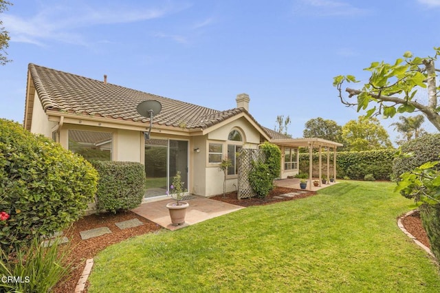 2101 Fox Den Ct, Oxnard, CA 93036 - rear view of house with a tiled roof, a yard, stucco siding, a patio area, and a chimney