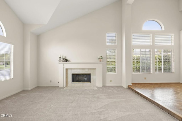 2101 Fox Den Ct, Oxnard, CA 93036 - unfurnished living room featuring baseboards, high vaulted ceiling, a tiled fireplace, and carpet