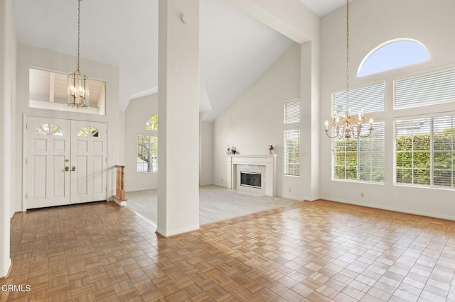 2101 Fox Den Ct, Oxnard, CA 93036 - foyer featuring a chandelier, a high end fireplace, high vaulted ceiling, and baseboards