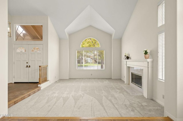 2101 Fox Den Ct, Oxnard, CA 93036 - unfurnished living room with a premium fireplace, high vaulted ceiling, carpet flooring, and baseboards