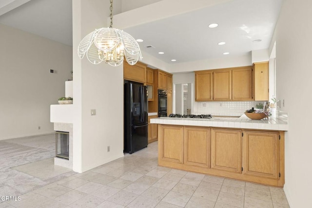 2101 Fox Den Ct, Oxnard, CA 93036 - kitchen featuring a peninsula, tasteful backsplash, baseboards, an inviting chandelier, and black appliances