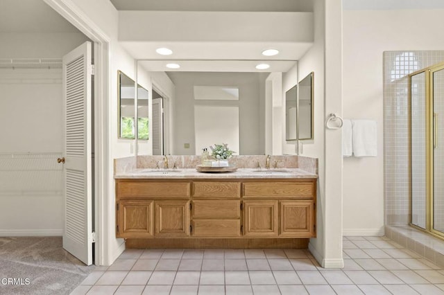 2101 Fox Den Ct, Oxnard, CA 93036 - full bathroom with a shower stall, a walk in closet, double vanity, and a sink