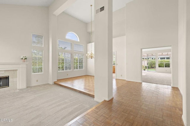 2101 Fox Den Ct, Oxnard, CA 93036 - unfurnished living room featuring high vaulted ceiling, a fireplace, carpet, a chandelier, and baseboards