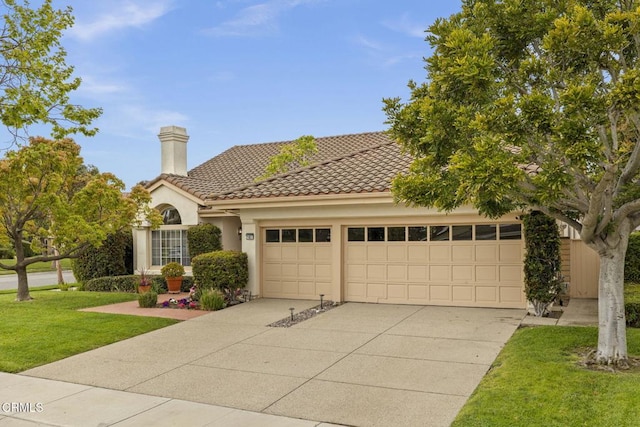 2101 Fox Den Ct, Oxnard, CA 93036 - mediterranean / spanish house featuring a front yard, an attached garage, concrete driveway, a tile roof, and stucco siding